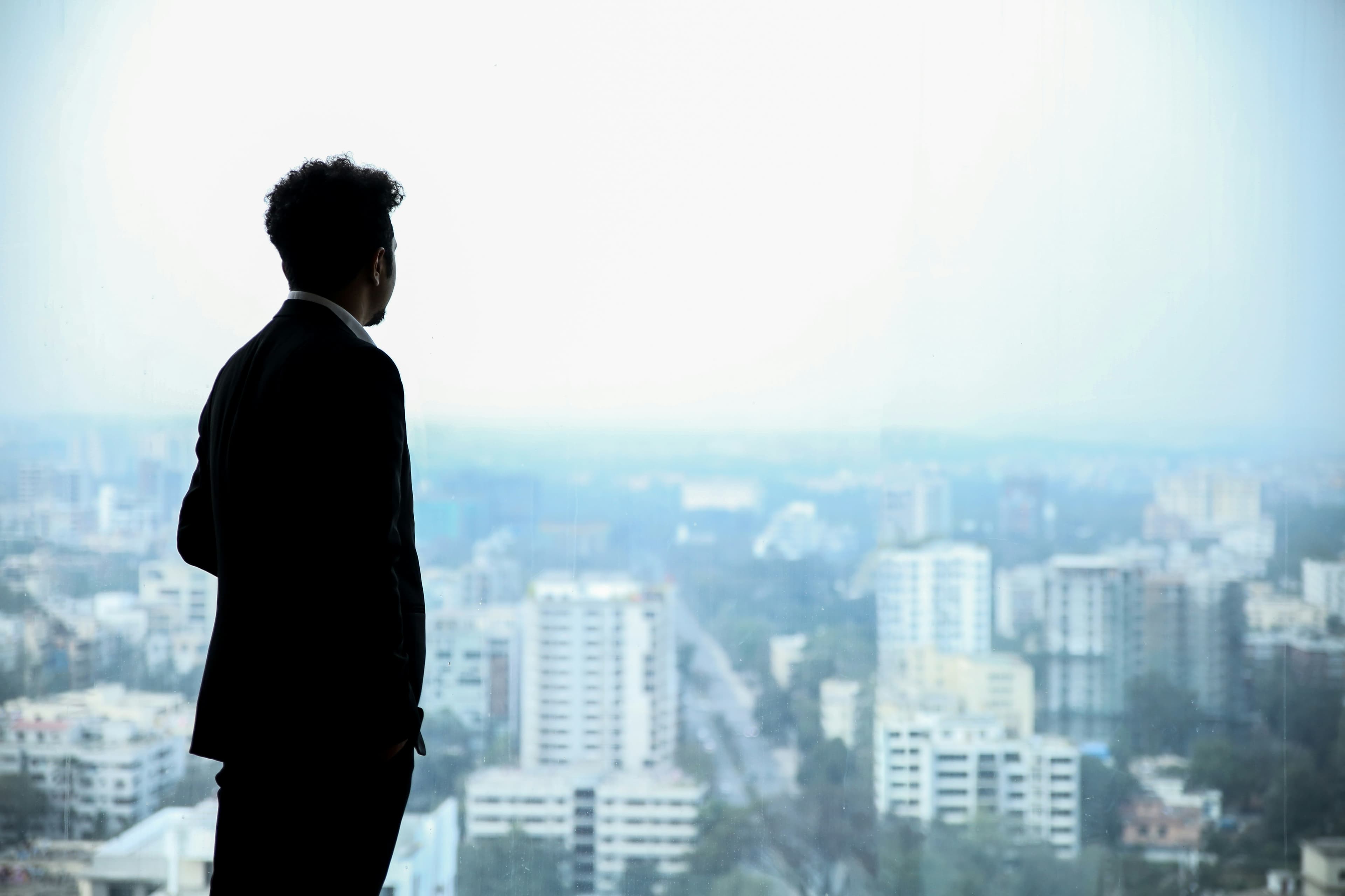Entrepreneur looking at city skyline — launch your vision with flexible capital
